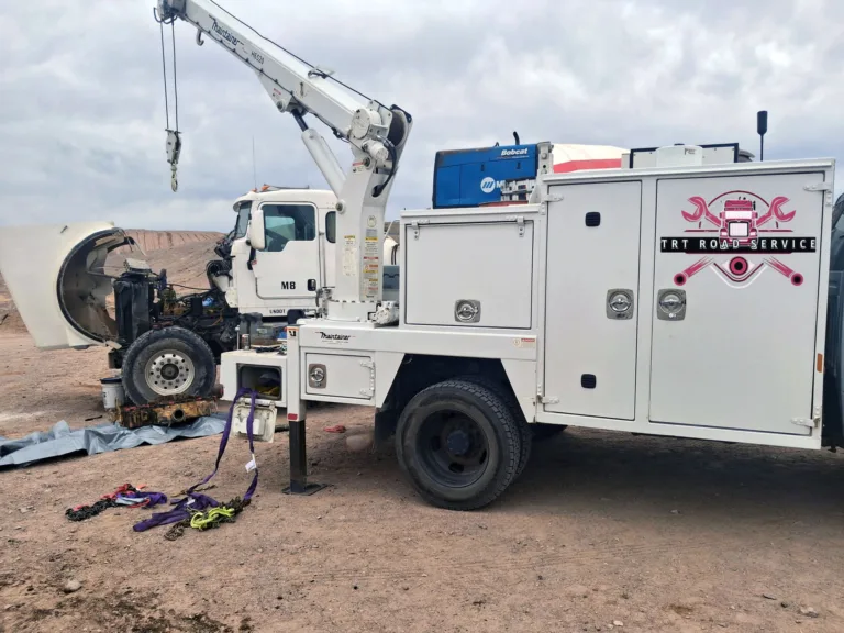 TRT Road Service truck with crane assisting a broken-down semi truck for mobile diesel engine repair.
